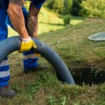 man pumping a septic tank