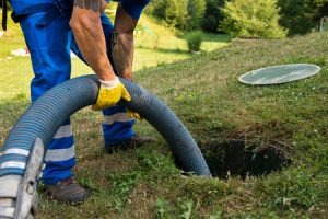 man pumping a septic tank